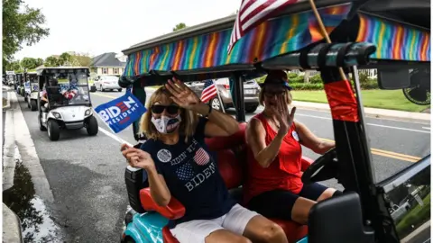 Getty Images Older voters at "The Villages" hold a pro-Biden parade in golf carts