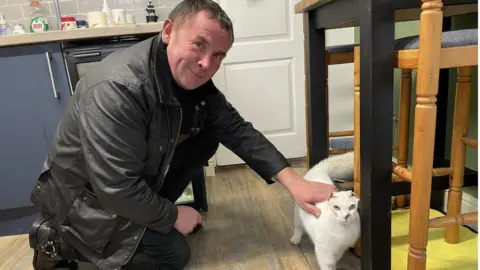 Dave Whitehouse with the cat