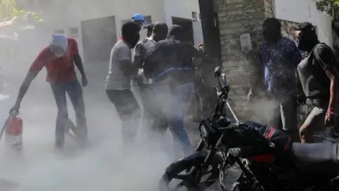 Protesters attempting to break into the Haitian prime minister's residence