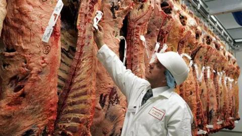 Press Association Butcher inspecting meat