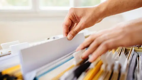 Getty Images Hands on files