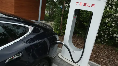 Getty Images Tesla car at a charging station