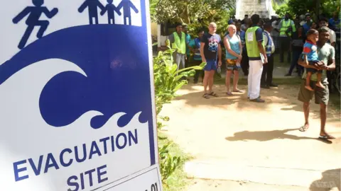 Getty Images Tourists take part in a tsunami evacuation drill in Hikkaduwa on September 5, 2018