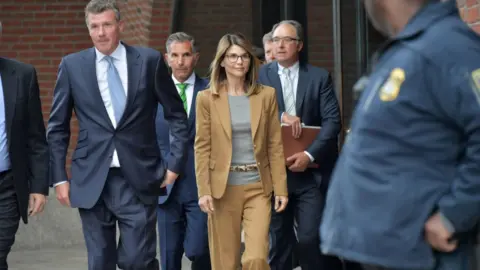 Paul Marotta/Getty Lori Loughlin exits the John Joseph Moakley U.S. Courthouse after appearing in Federal Court to answer charges stemming from college admissions scandal on April 3, 2019 in Boston, Massachusetts.