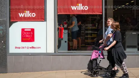 PA Media People walk in front of Wilko shop