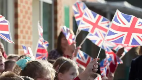 Getty Images Children waving union jacks