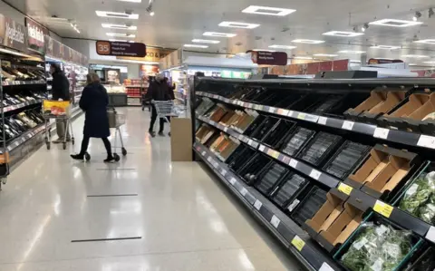 PA Media Empty supermarket shelves