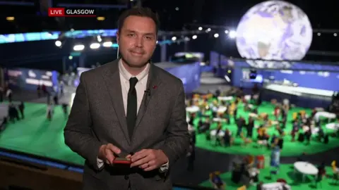 BBC Steffan Messenger on screen at the COP26 conference