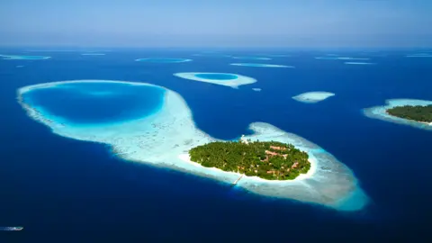 Getty Images Aerial view of atolls in the Maldives, Indian Ocean