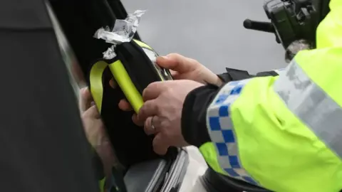 PA Media Police officer with drug-driving test kit
