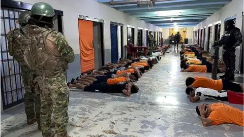 EPA-EFE/REX/Shutterstock Soldiers monitor inmates at a jail in the city of Guayaquil