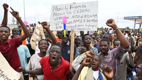 AFP Protesters gathered outside a French military base after Ecowas announced the activation of a standby military force.