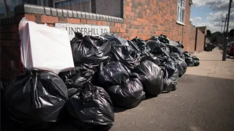 Getty Images Bin bags piled up in Birmingham