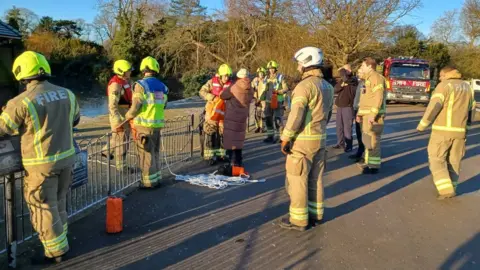 LFB Ponzo is reunited with her owner while firefighters look on