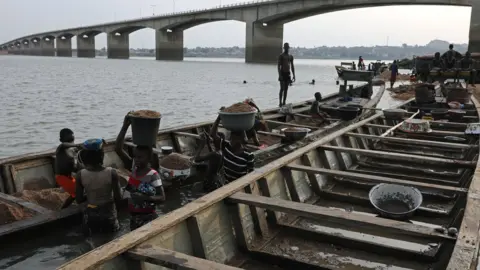 Reuters Workers carry sand at the bank of Benue River in Benue, Nigeria - Wednesday 11 April 2018