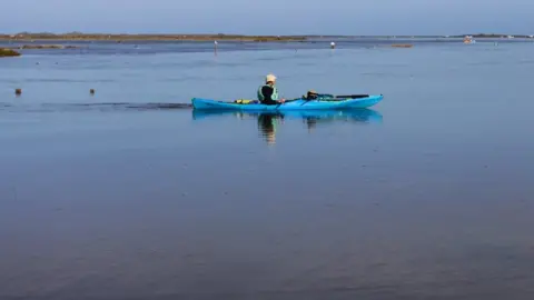 Dave Fincham Person in kayak on flooded car park