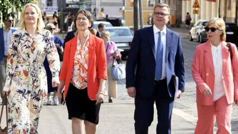 KIMMO PENTTINEN Finns Party chair Riikka Purra, Christian Democrats chair Sari Essayah, National Coalition Party chair PM-designate Petteri Orpo and Swedish People's Party chair Anna-Maja Henriksson arrive at a press conference in Helsinki, Finland, on 16 June 2023