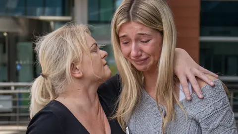 PA Media Hollie Dance (left) with Ella Carter outside the Royal London hospital