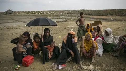 Getty Images Rohingya refugees resting after crossing into Bangladesh