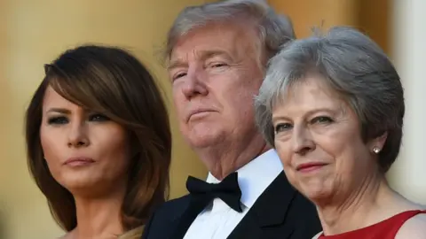 GEOFF PUGH/ AFP/ Getty images First Lady Melania Trump, her husband and Theresa May are pictured on the steps of Blenheim Palace on July 12, 2018