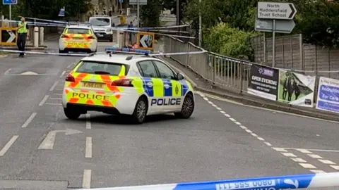 Police scene after boy, 15, stabbed to death in Huddersfield