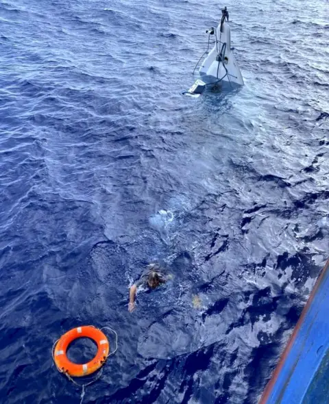 US Coast Guard/Jacksonville Stuart Bee swims to a buoy