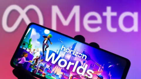 Getty Images An image of a phone showing horizon worlds screen with meta logo behind