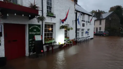 Claire Kingdon Flood water up to a pub door in Crickhowell