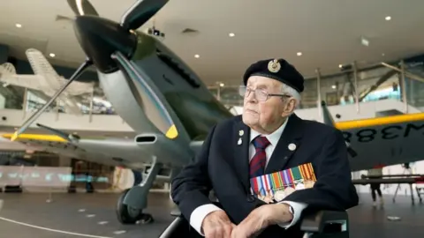 PA Media Second World War veteran Norman Lewis with the Spitfire