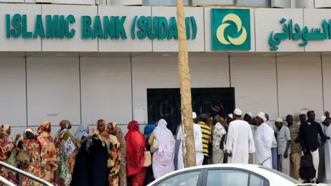 Reuters Sudanese customers queue to access money services at the Faisal Islamic Bank (Sudan) in Khartoum, Sudan June 11, 2019.
