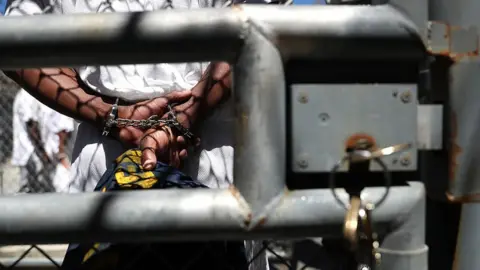 Getty Images A condemned inmate stands with handcuffs on as he preapres to be released from the exercise yard back to his cell at San Quentin State Prison's death row on August 15, 2016 in San Quentin, California