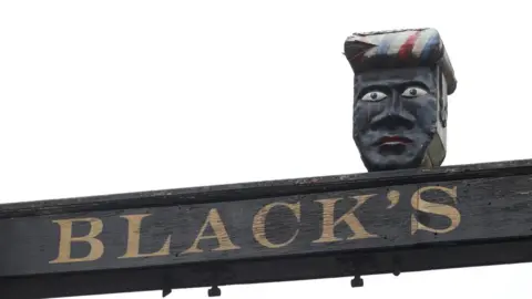 Reuters Sign above The Green Man and Black's Head Hotel