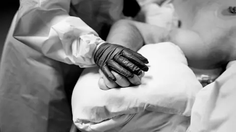 BBC A Covid patient in the ICU is likely intubated and put into an induced coma.