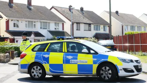 PA Media Police officer and car in Meadow Close