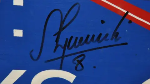 Signature on the Drum & Monkey sign