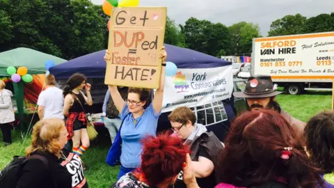 Stuart Barnes Person holding a placard next to the Conservative tent at the 2017 event