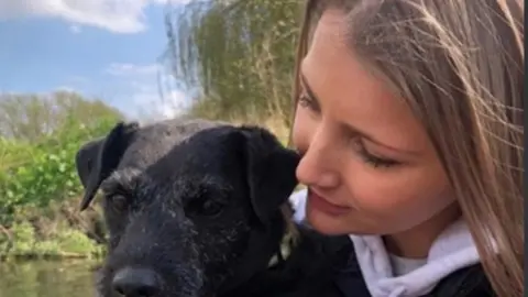 PA Media Georgie Cooper and a dog