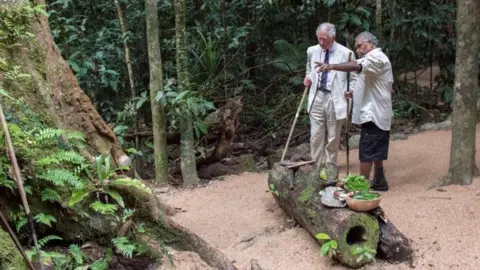 Reuters Prince Charles is accompanied by Roy Gibson, an elder of the Kuku Yalanji tribe, during a visit to the Daintree Rainforest in Australia