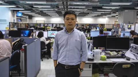 Getty Images Apple Daily editor-in-chief Ryan Law posing for a portrait in the newsroom in Hong Kong