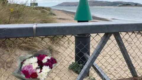 flowers on a railing near Morfa beach