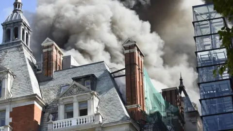 Gordon Lewis Smoke billowing from the building