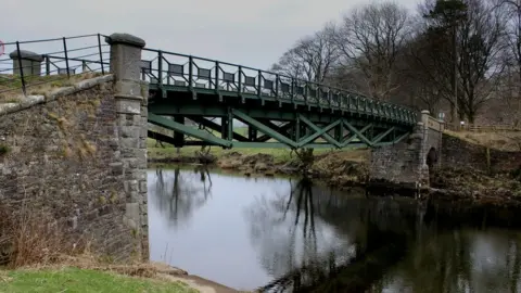 Geograph/Chris Heaton Rigmaden Bridge is a wrought iron structure that carries a minor road across the river