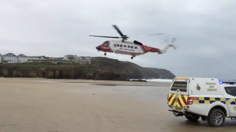 BBC Search and rescue helicopter landing on beach