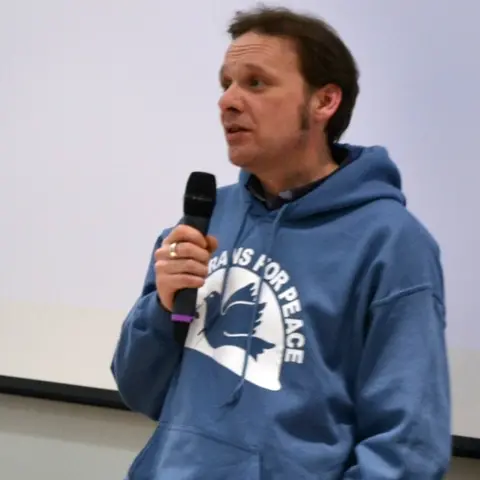 Lee Lavis Lee in a "veterans for peace" hoodie