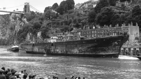 SS Great Britain Trust  Archive photo of the ship sailing into Bristol, passing under the Clifton Suspension Bridge, also by IKB