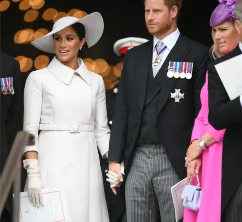 Getty Images Meghan, Duchess of Sussex, Britain's Prince Harry, Duke of Sussex, and Zara Tindall