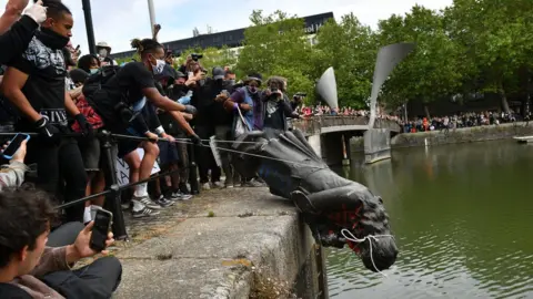 PA Media Statue of Edward Colston being thrown into Bristol harbour