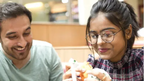 Getty Images Couple eating burgers