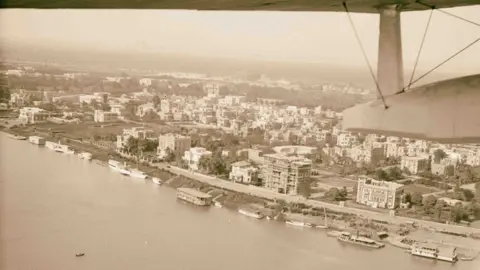 Sepia Times Photograph taken in the 1932 showing houseboats and other vessels on the Nile in Cairo, Egypt