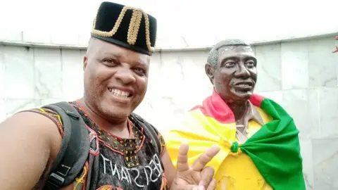 Andre Blaise Essama Andre Blaise Essama and the statue of Samuel Mbappé Léppé,